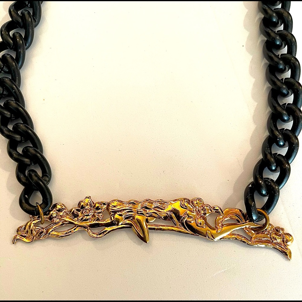 Necklace with black chain and gold woman center.